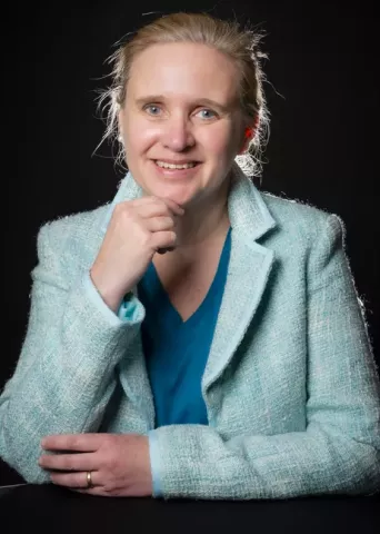 Portrait photo of guest speaker Mieke Deketelaere at Springbok's Time To Make Sense 2025 Summit at the Verbeken Foundation contemporary art museum. The visual states that she is Springbok's AI expert, strategist and keynote speaker.